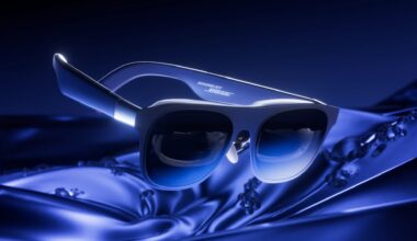 Blue Bose sunglasses resting on silky blue fabric, logo visible on the arm.