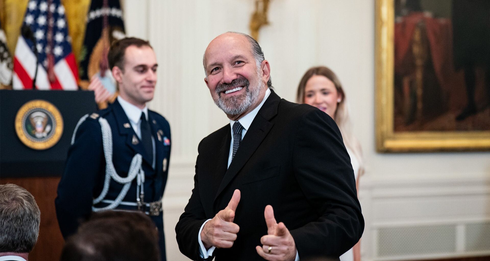 Howard Lutnick giving the double finger gun gesture.