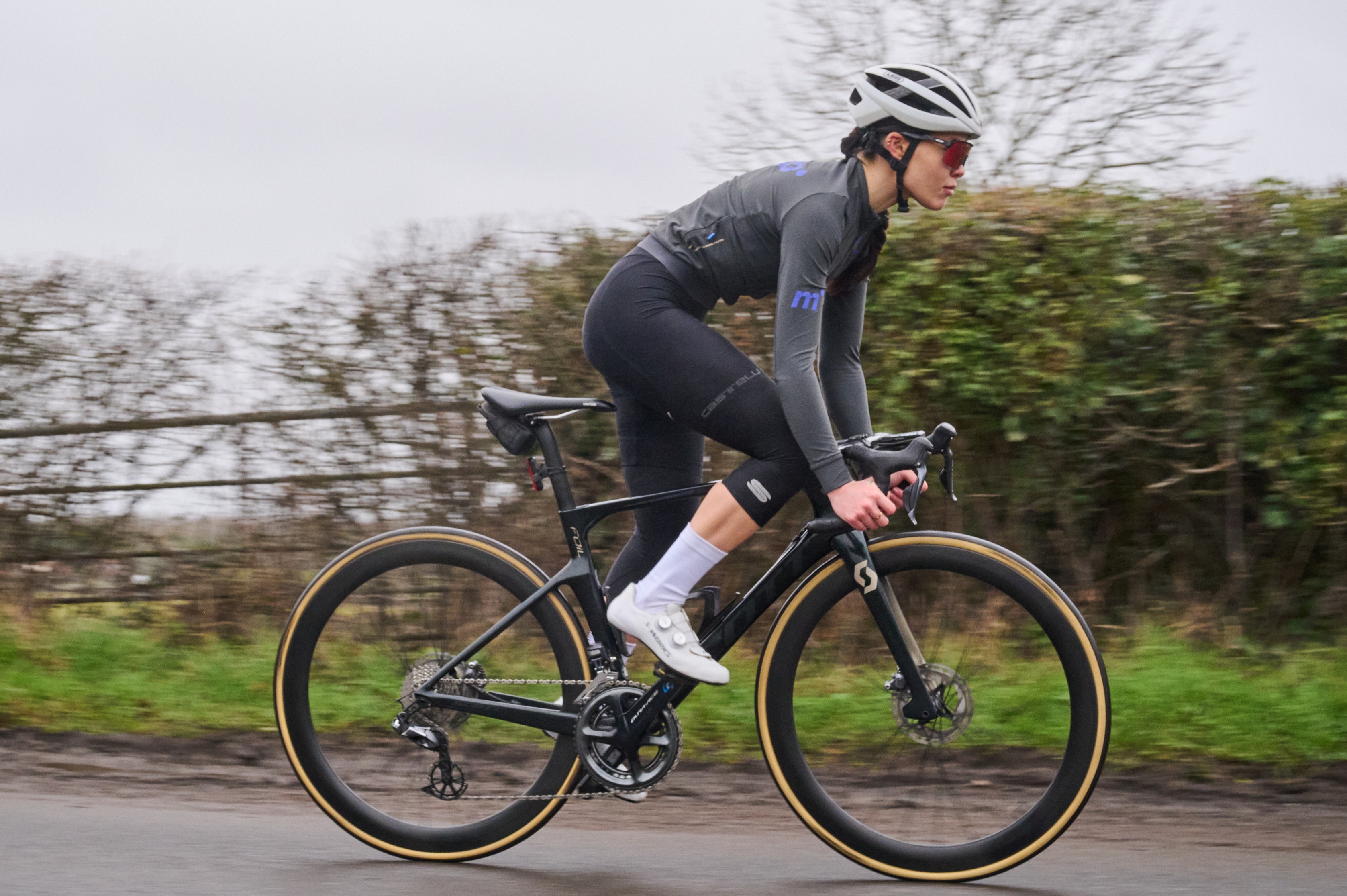 A woman rides a road bike