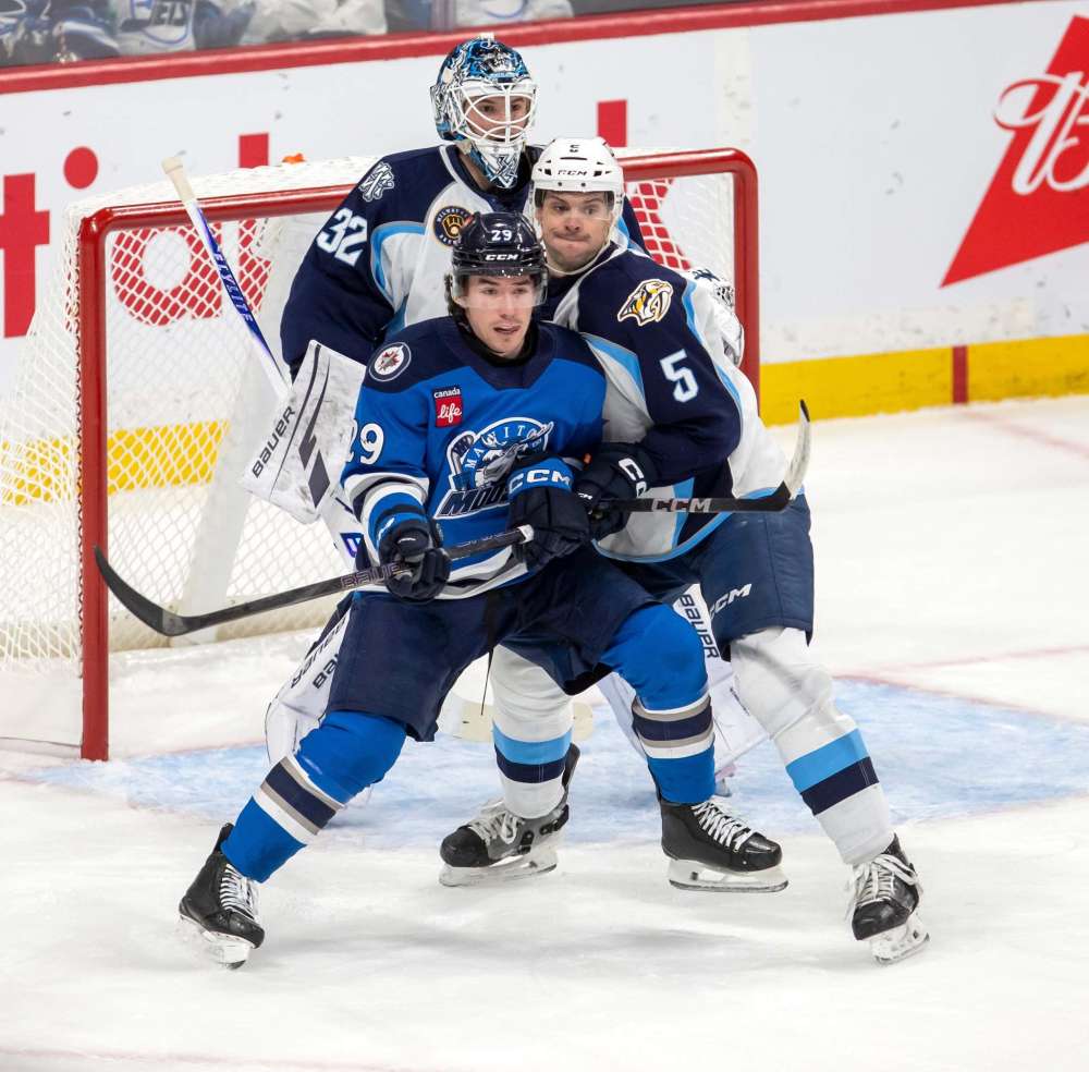 BROOK JONES / FREE PRESS
Manitoba Moose centre Brayden Yager fights for position in the slot against Admirals defenceman Kevin Gravel, while Admirals goaltender Matthew Murray keeps an eye on the play.