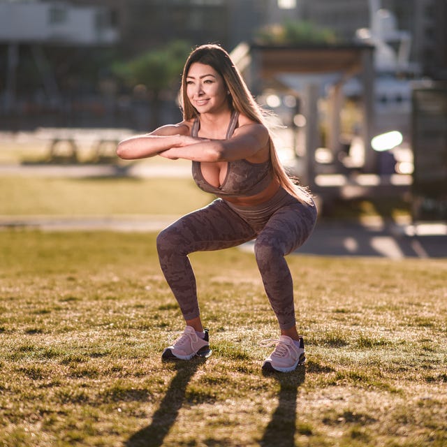 Smiling woman exercising in public park Smiling woman exercising in public park