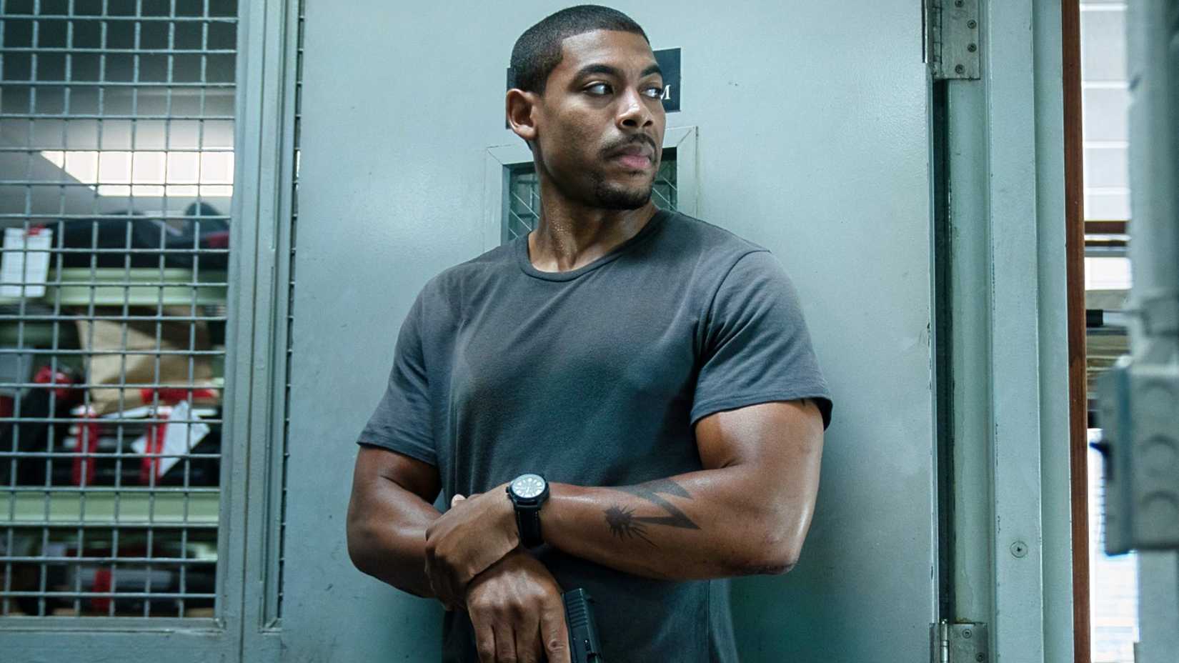 Aaron Pierre as Richmond holding a gun in Rebel Ridge