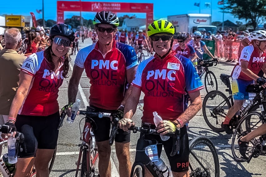 Cyclists participating in an event, standing with their bicycles. Cyclists participating in an event, standing with their bicycles.