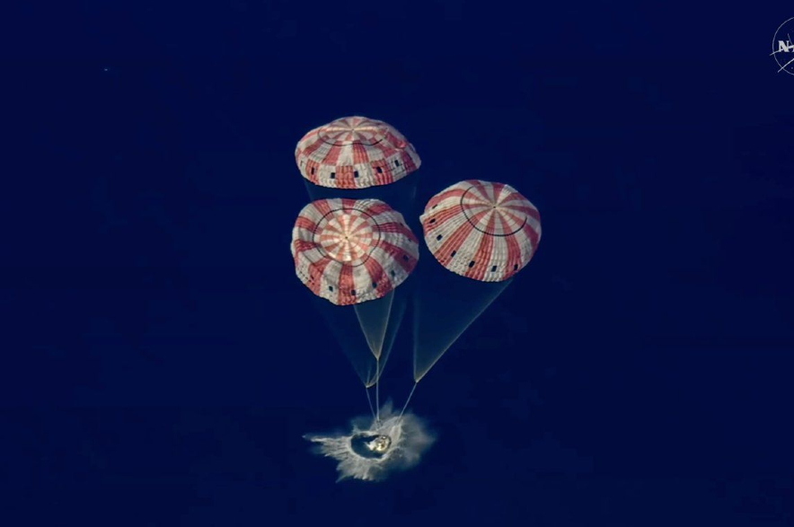 The Artemis II Orion capsule splashes down in the Pacific Ocean.