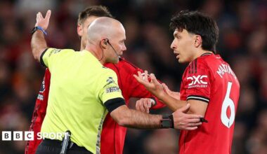 Paul Tierney speaks to Lisandro Martinez after issuing the Manchester United centre-back with a red card