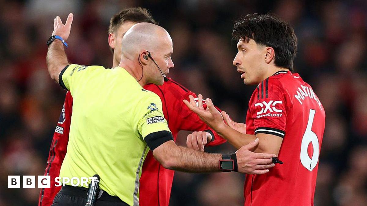 Paul Tierney speaks to Lisandro Martinez after issuing the Manchester United centre-back with a red card
