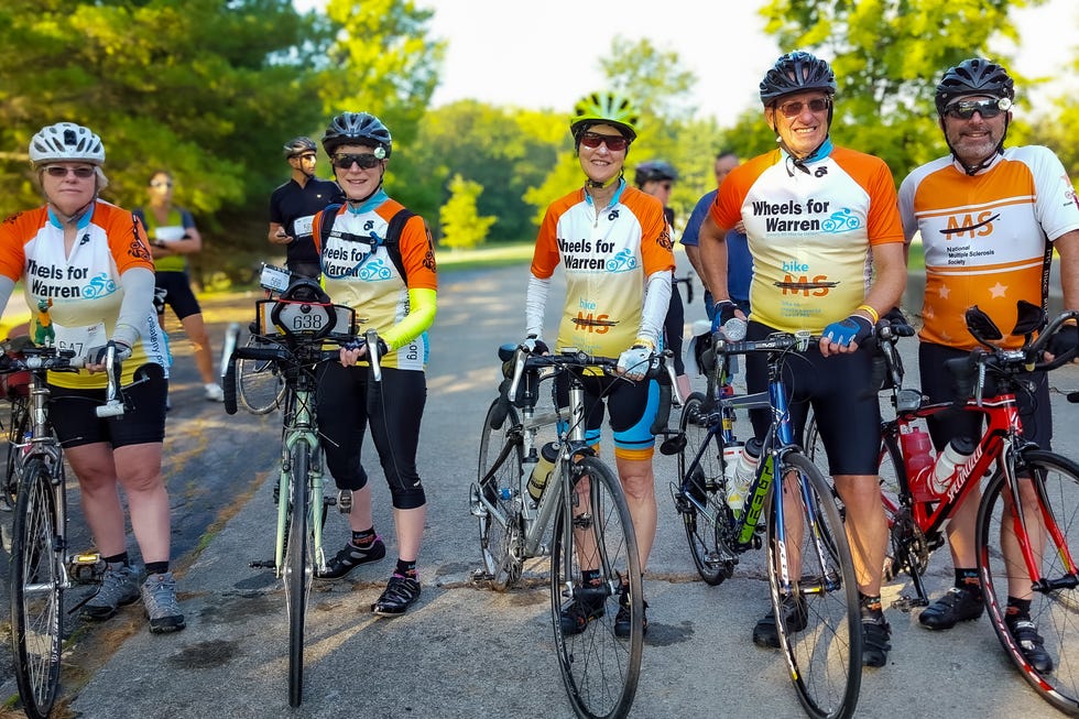 Group of cyclists in matching jerseys preparing for a ride. Group of cyclists in matching jerseys preparing for a ride.