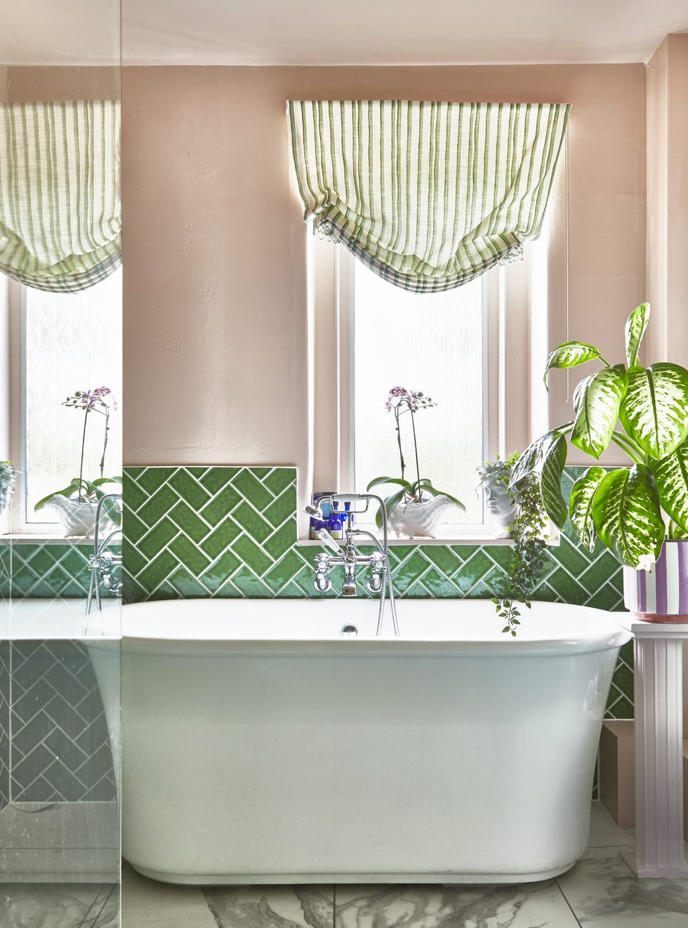 modern bathroom with a bathtub and green tiles