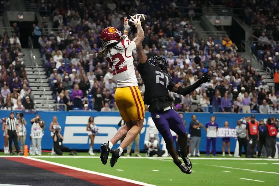Dec 30, 2025; San Antonio, TX, USA; Southern California Trojans running back Bryan Jackson (21) attempts to catch the ball against TCU Horned Frogs safety Bud Clark (21) in the first half during the Alamo Bowl at Alamodome. Mandatory Credit: Kirby Lee-Imagn Images