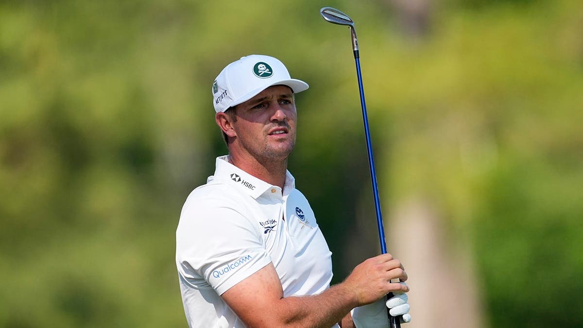 Bryson DeChambeau watching his tee shot on the 12th hole at Augusta National Golf Club