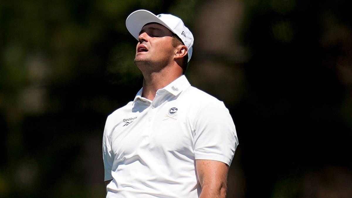 Bryson DeChambeau reacting to his shot on the fairway at Augusta National Golf Club