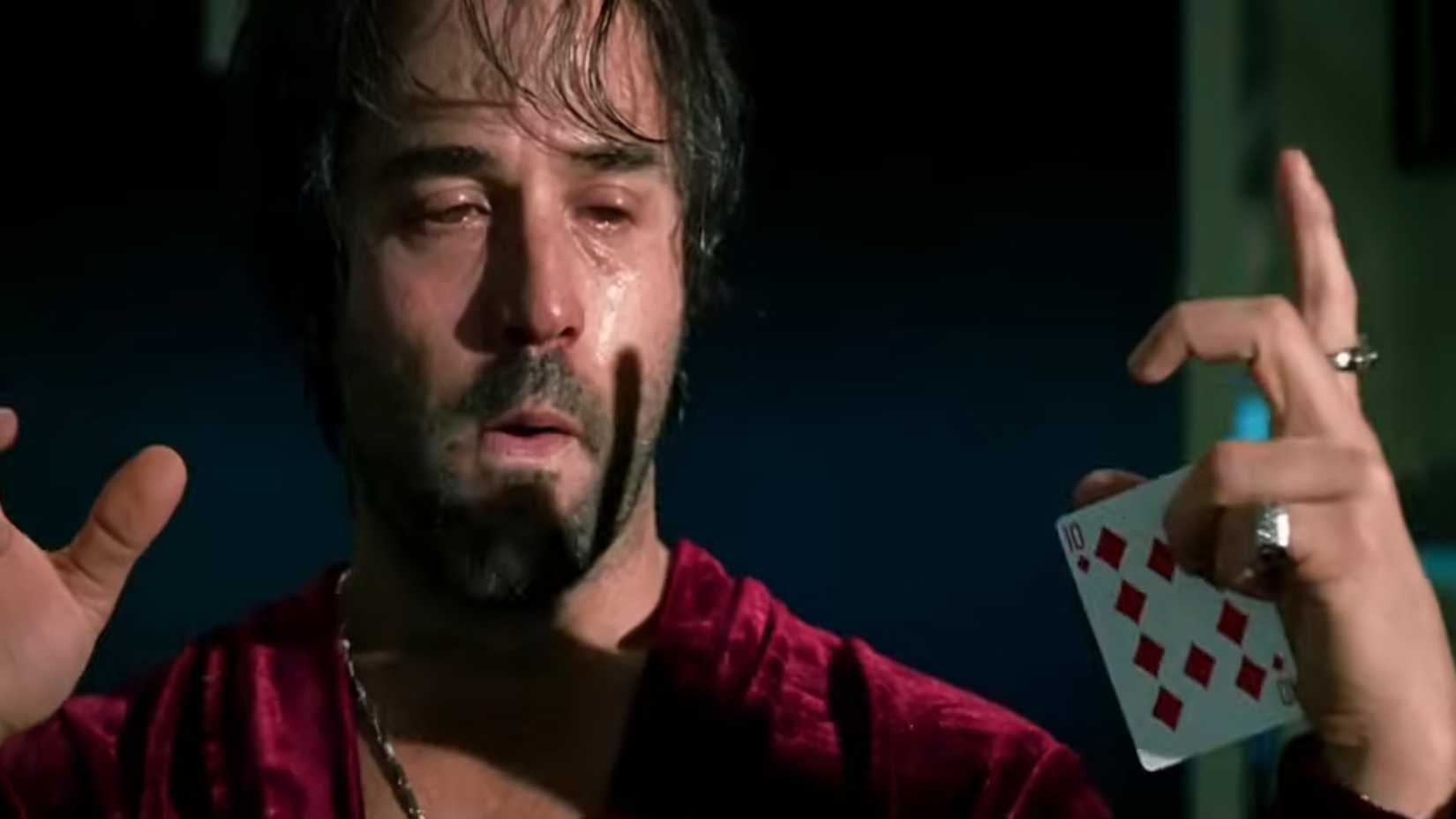 Buddy Israel (Jeremy Piven) looking tired holding a playing card in Smokin' Aces