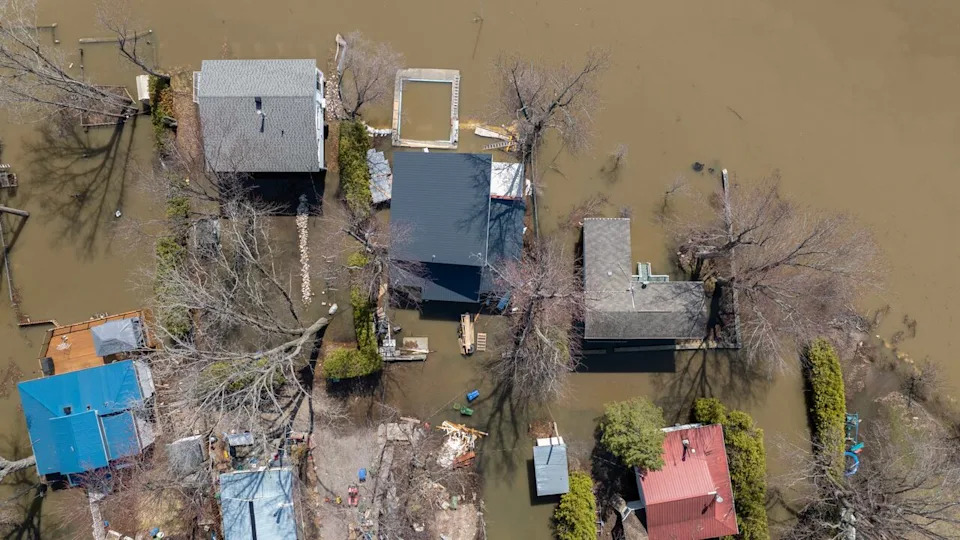 Some homes sit surrounded by water in Luskville, Que., on April 22, 2026.