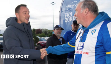 John Terry shakes hands with a Colchester fan