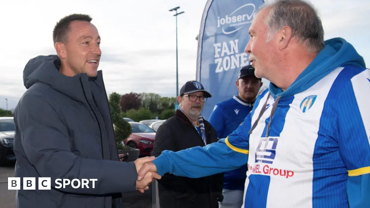 John Terry shakes hands with a Colchester fan