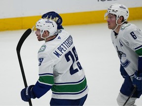 Vancouver Canucks defenseman Marcus Pettersson, left, celebrates after scoring the go-ahead goal with right wing Brock Boeser in the third period of an NHL hockey game against the Colorado Avalanche Wednesday, April 1, 2026, in Denver.