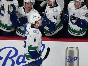 Vancouver Canucks right wing Brock Boeser, front, is congratulated as he passes the team box after scoring his third goal of the contest in the third period of an NHL hockey game against the Colorado Avalanche Wednesday, April 1, 2026, in Denver.