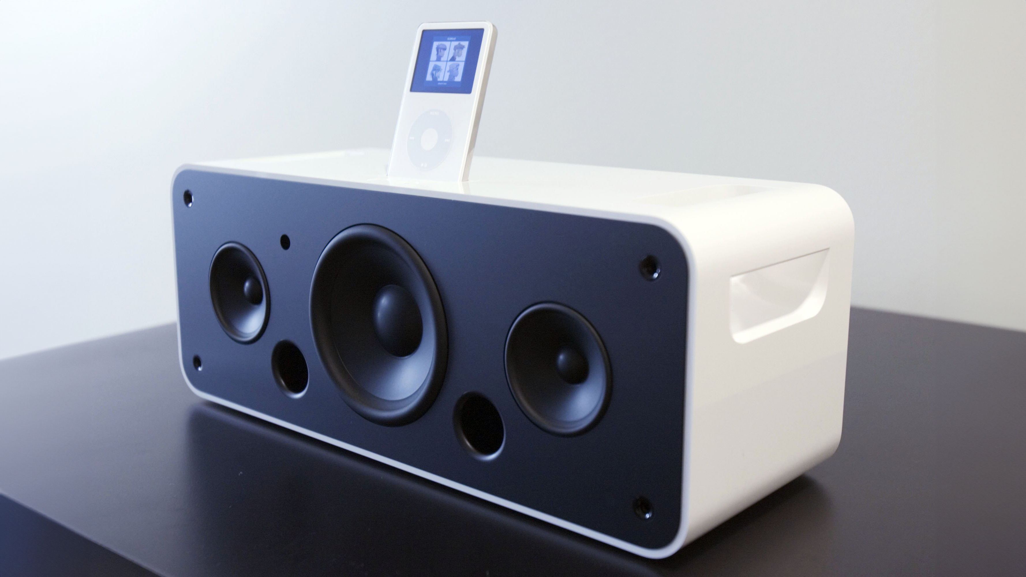An iPod Hi-Fi sitting on a black table