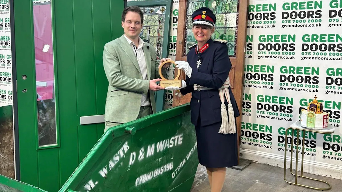 Man receives King's Award from inside a skip