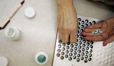 A pharmacy technician filling out a prescription