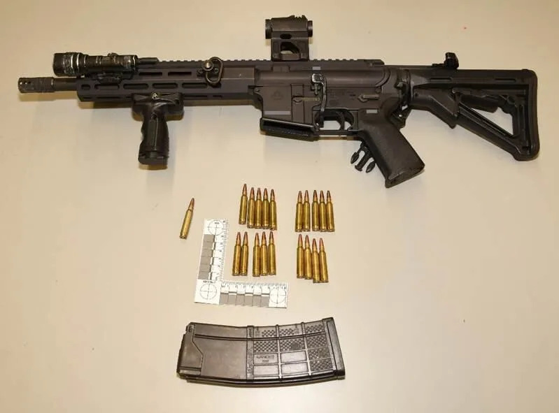 The subject officer's Colt C8 rifle with light and laser scope. The magazine contained 20 live rounds of ammunition, the SIU says.