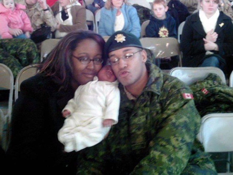 Lionel and Shanna Desmond with their infant daughter, Aaliyah. They are a Black man and woman in their thirties. He is dressed in military uniform.