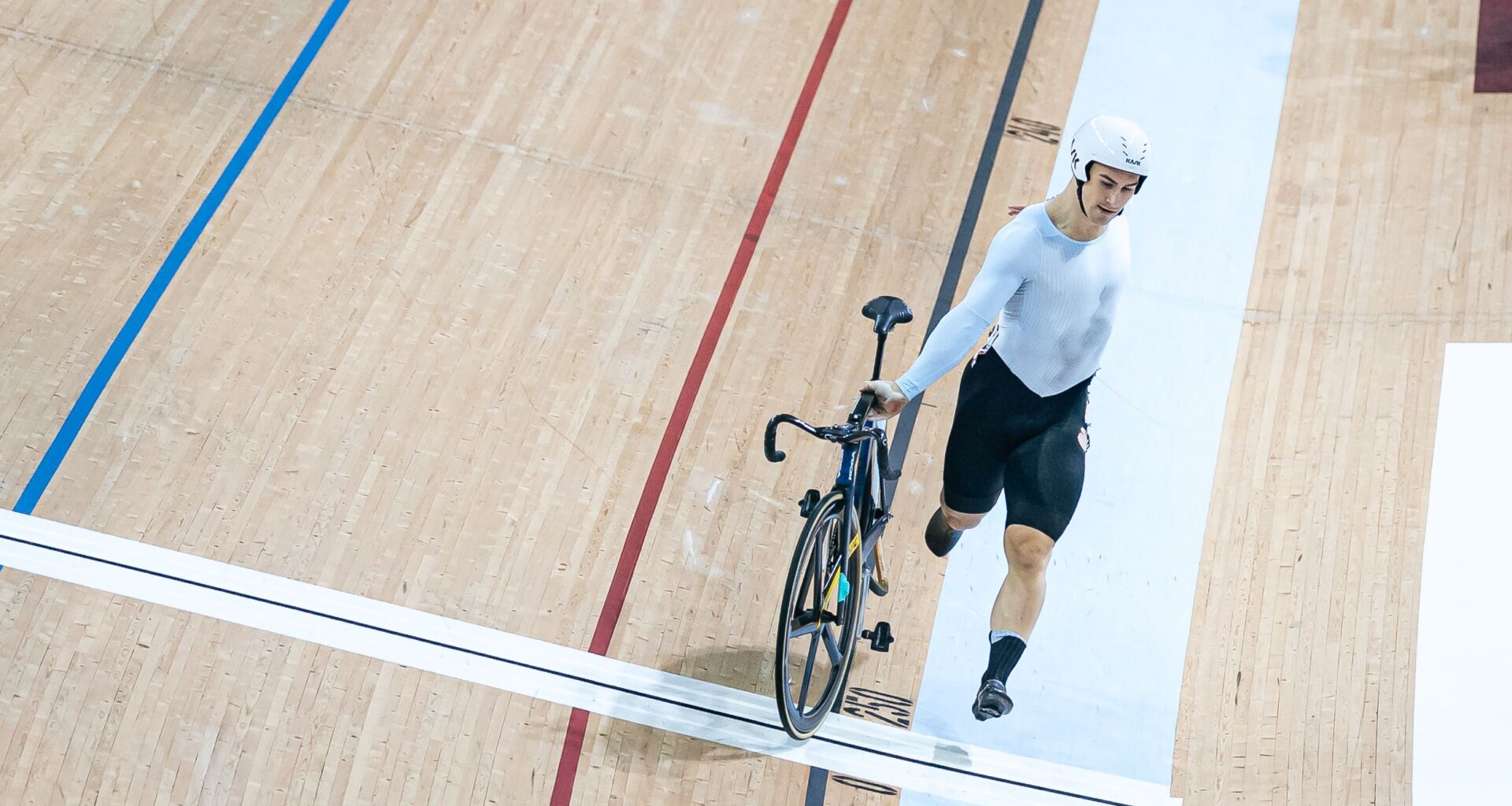 Track rider runs on foot across line after massive pile-up