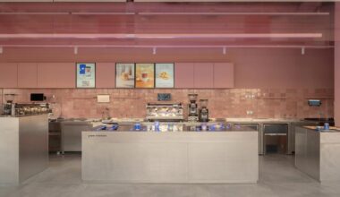 raw concrete meets marshmallow-inspired palette within drinkit café