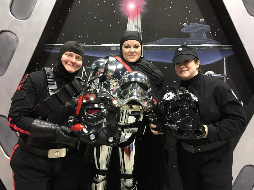 Teresa Nuthall poses for a photo in her Captain Phasma costume at Calgary Expo in 2019, alongside fellow 501st Legion members Cara Skjaveland and Kathy Ma.