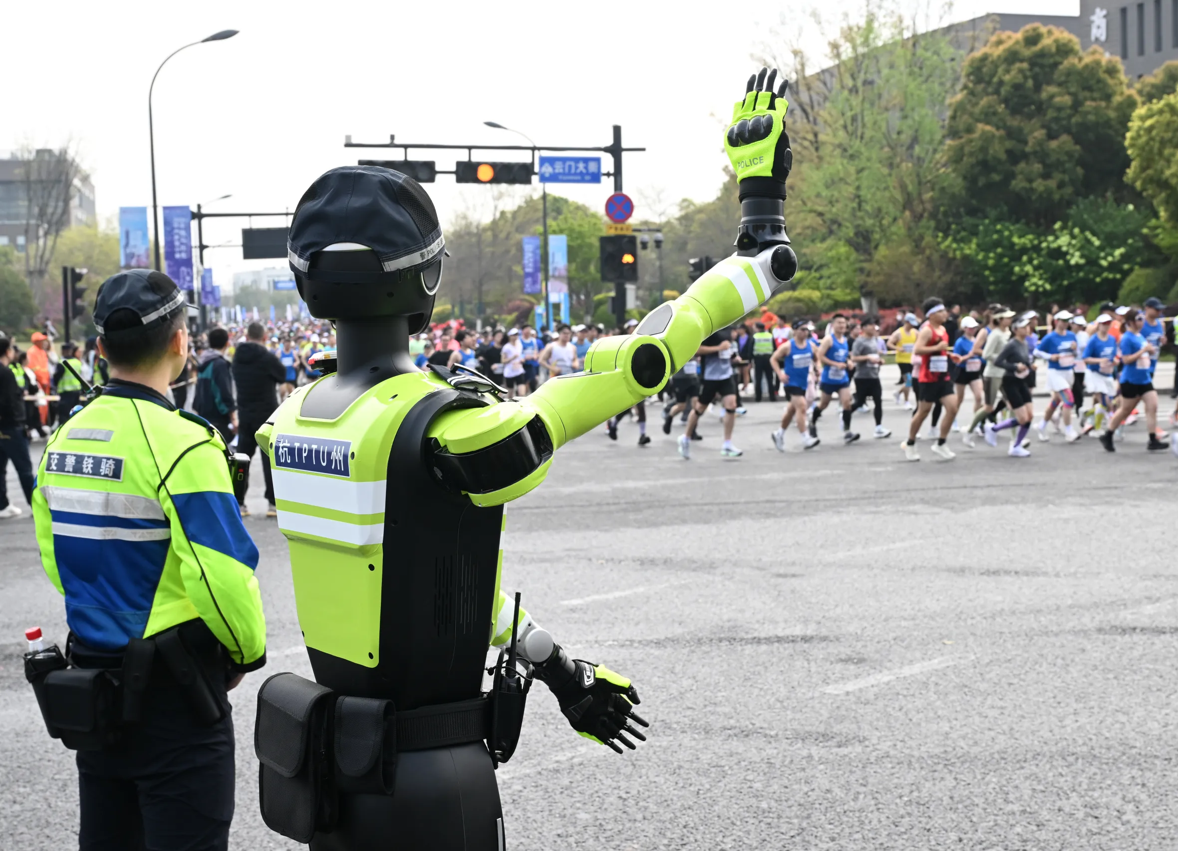 An AI traffic management robot and a human police officer overseeing a marathon race.
