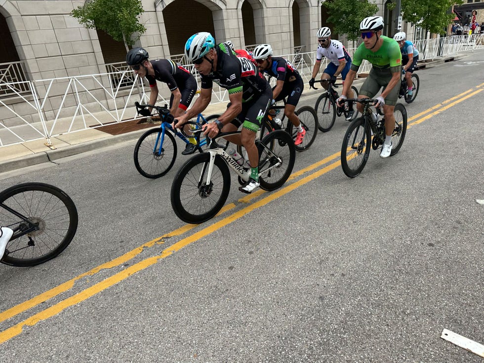 Group of cyclists participating in a race on a city street. Group of cyclists participating in a race on a city street.