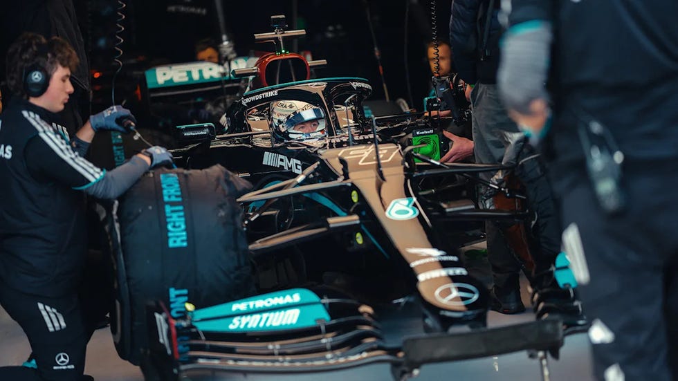 formula 1 car being serviced in a garage formula 1 car being serviced in a garage