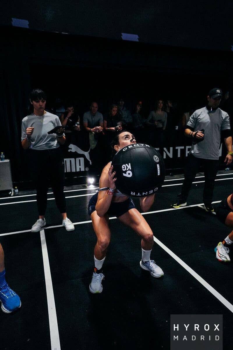 woman throwing a ball at hyrox