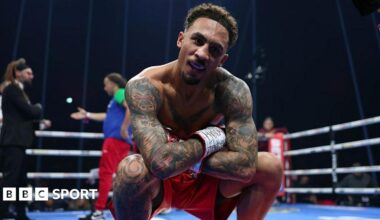 Ben Whittaker crouching down, posing for a picture in red shorts