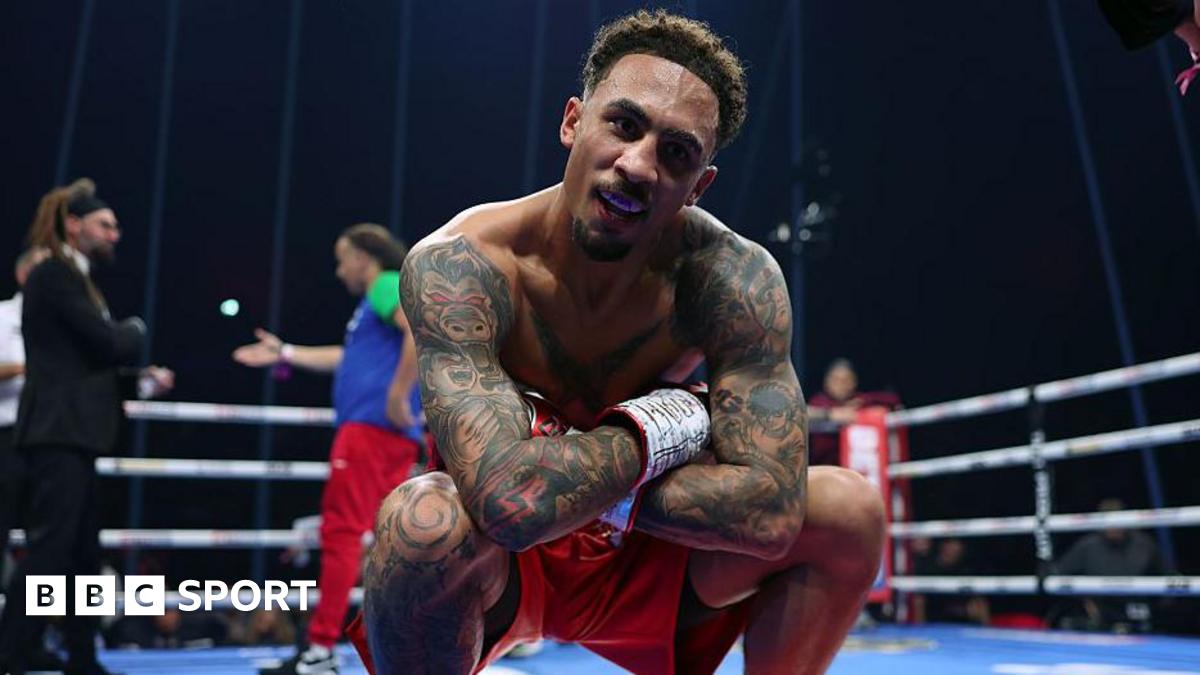 Ben Whittaker crouching down, posing for a picture in red shorts