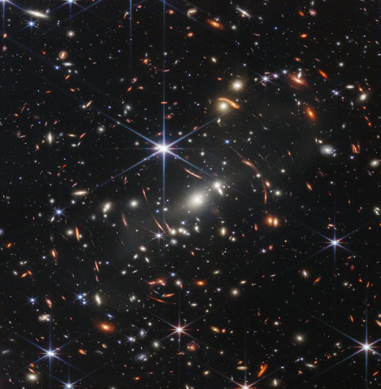 Many galaxies, represented as bright dots, some blurred, against a dark background.