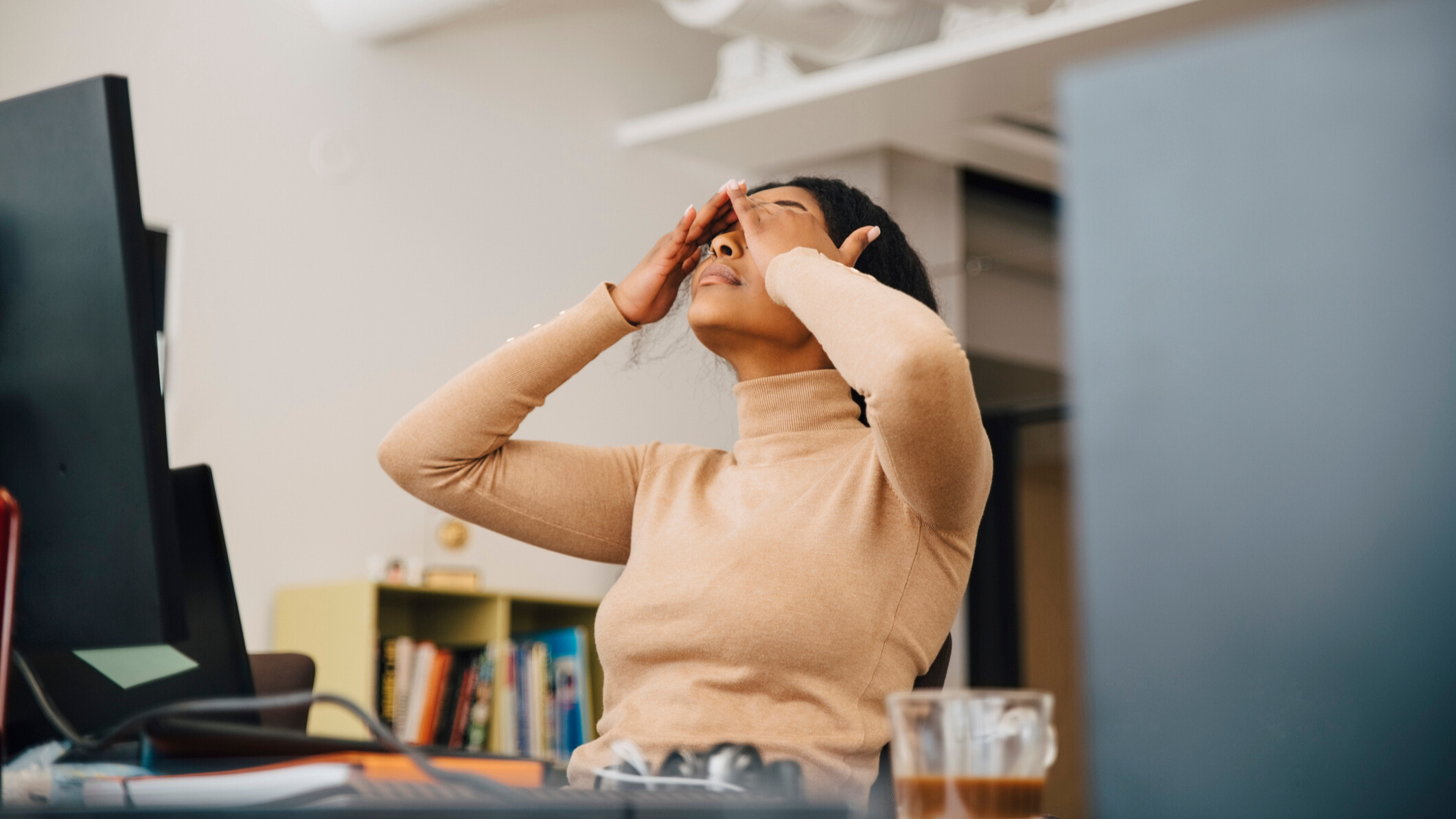 Woman feeling tried and stressed at work