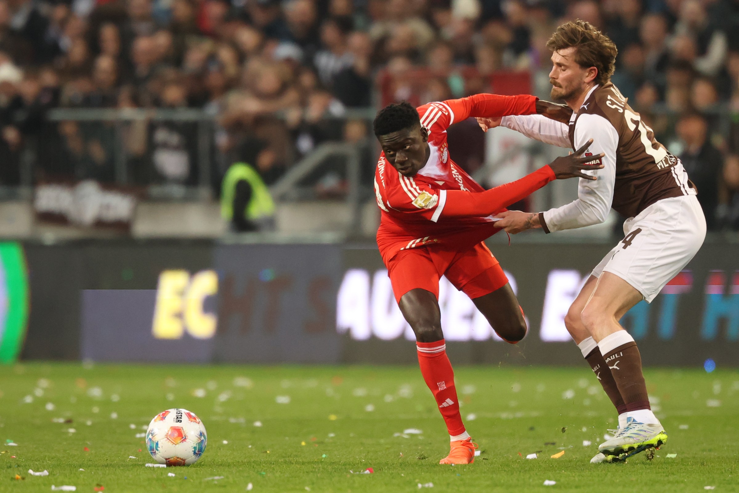 11 April 2026, Hamburg: Soccer, Men: Bundesliga, FC St. Pauli - Bayern Munich, Matchday 29, Millerntor-Stadion, Bara Sapoko Ndiaye (Bayern Munich) and Connor Metcalfe (r, FC St. Pauli) fight for the ball. IMPORTANT NOTE: In accordance with the regulations of the DFL German Football League and the DFB German Football Association, it is prohibited to use or have used photographs taken in the stadium and/or of the match in the form of sequential images and/or video-like photo series. Photo: Christian Charisius/dpa (Photo by Christian Charisius/picture alliance via Getty Images)