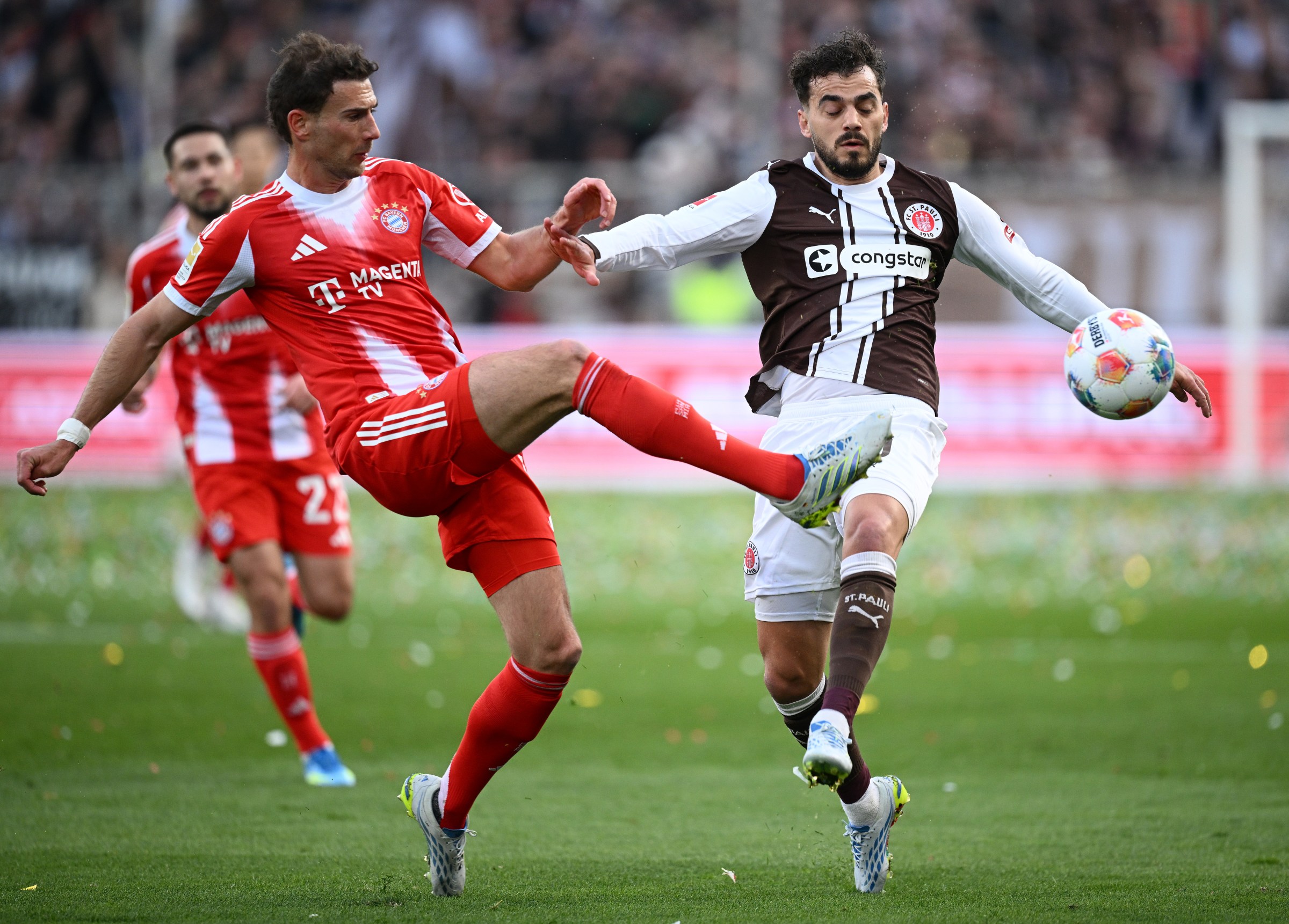 HAMBURG, GERMANY - APRIL 11: Danel Sinani of FC St. Pauli is challenged by Leon Goretzka of FC Bayern Munich during the Bundesliga match between FC St. Pauli and FC Bayern München at Millerntor Stadium on April 11, 2026 in Hamburg, Germany. (Photo by Stuart Franklin/Getty Images)