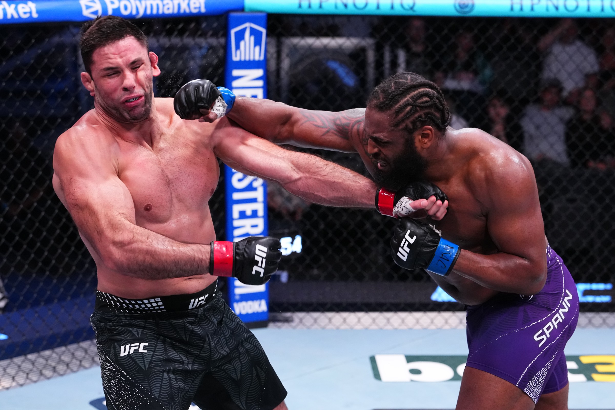 LAS VEGAS, NEVADA - APRIL 25: (R-L) Ryan Spann knocks out Marcus Buchecha of Brazil in a heavyweight fight during the UFC Fight Night event at Meta APEX on April 25, 2026 in Las Vegas, Nevada. (Photo by Jeff Bottari/Zuffa LLC)