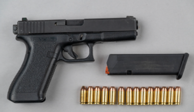Glock 22 firearm with a magazine clip and ammunition