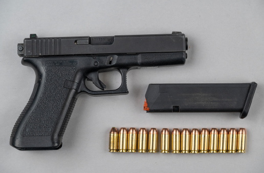 Glock 22 firearm with a magazine clip and ammunition