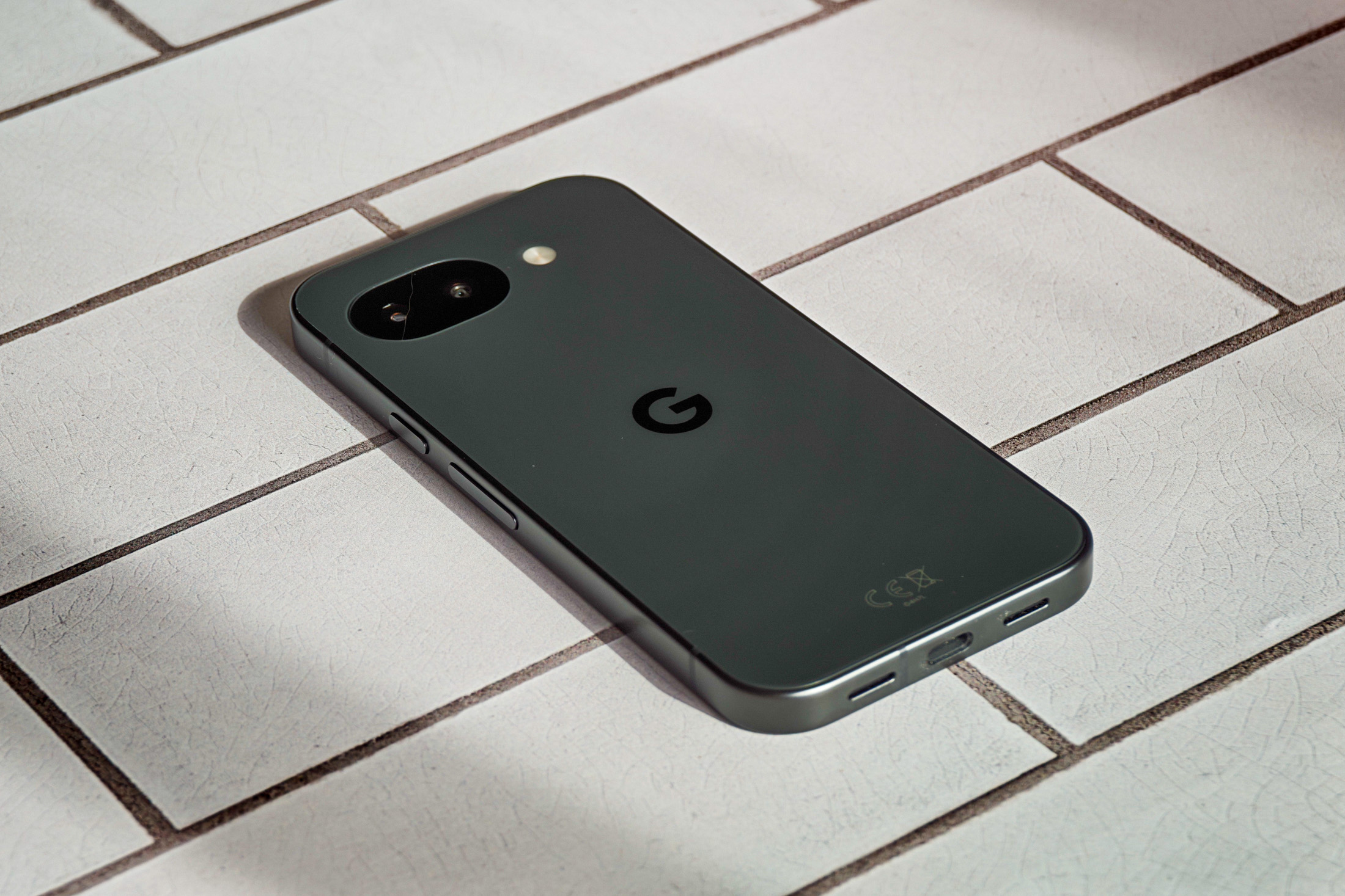 Photo of Google Pixel 10A lying on white tiles