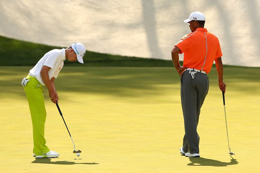 Guan Tianlang and Tiger Woods