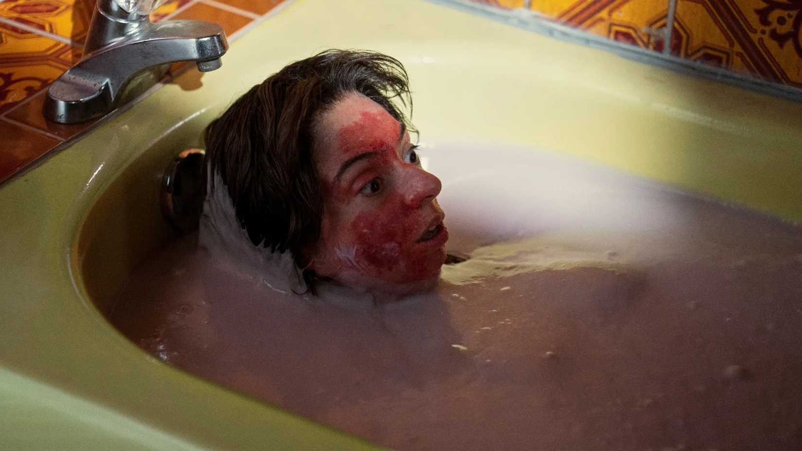 A still image of Guillermo Del Toro’s Cabinet Of Curiosities episode 4 shows a woman in a bath of blood