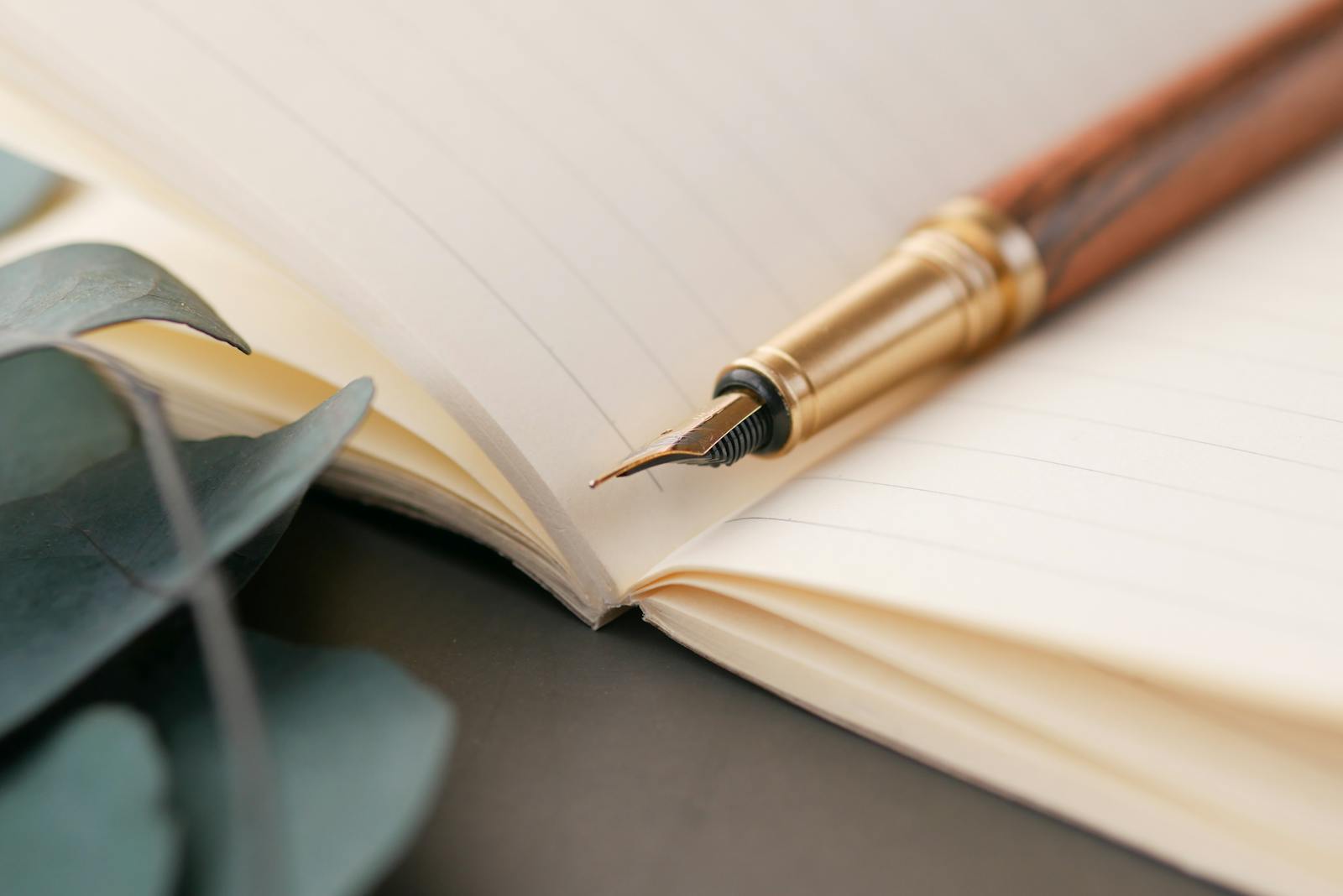 hands writing in notebook