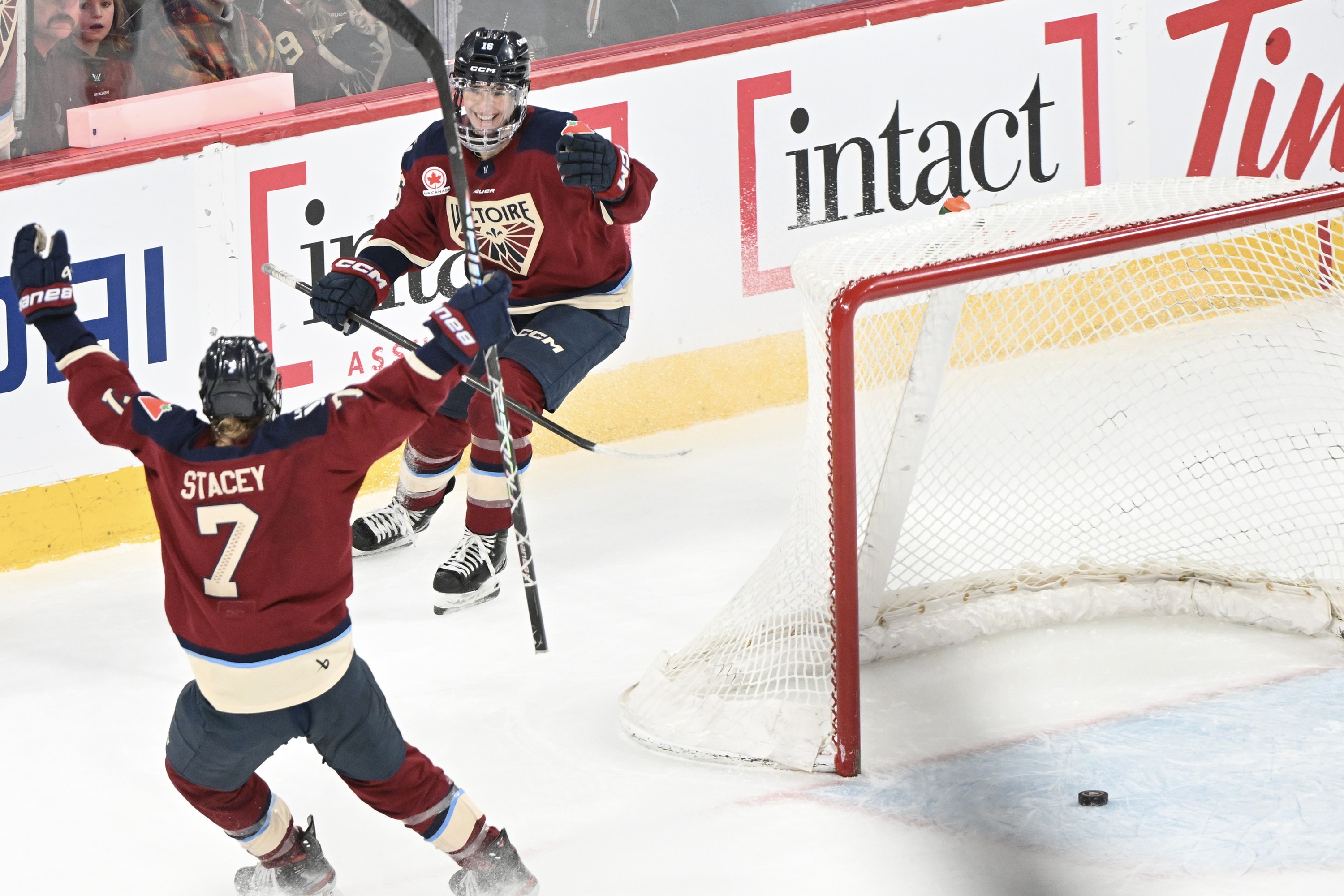 Montreal Victoire's Hayley Scamurra (16) celebrates with teammate Laura Stacey (7) after scoring an empty net goal