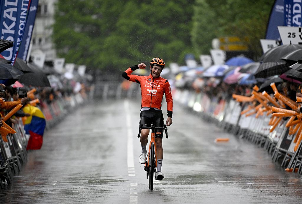 Team Ineos' US rider AJ August celebrates winning the sixth and last stage