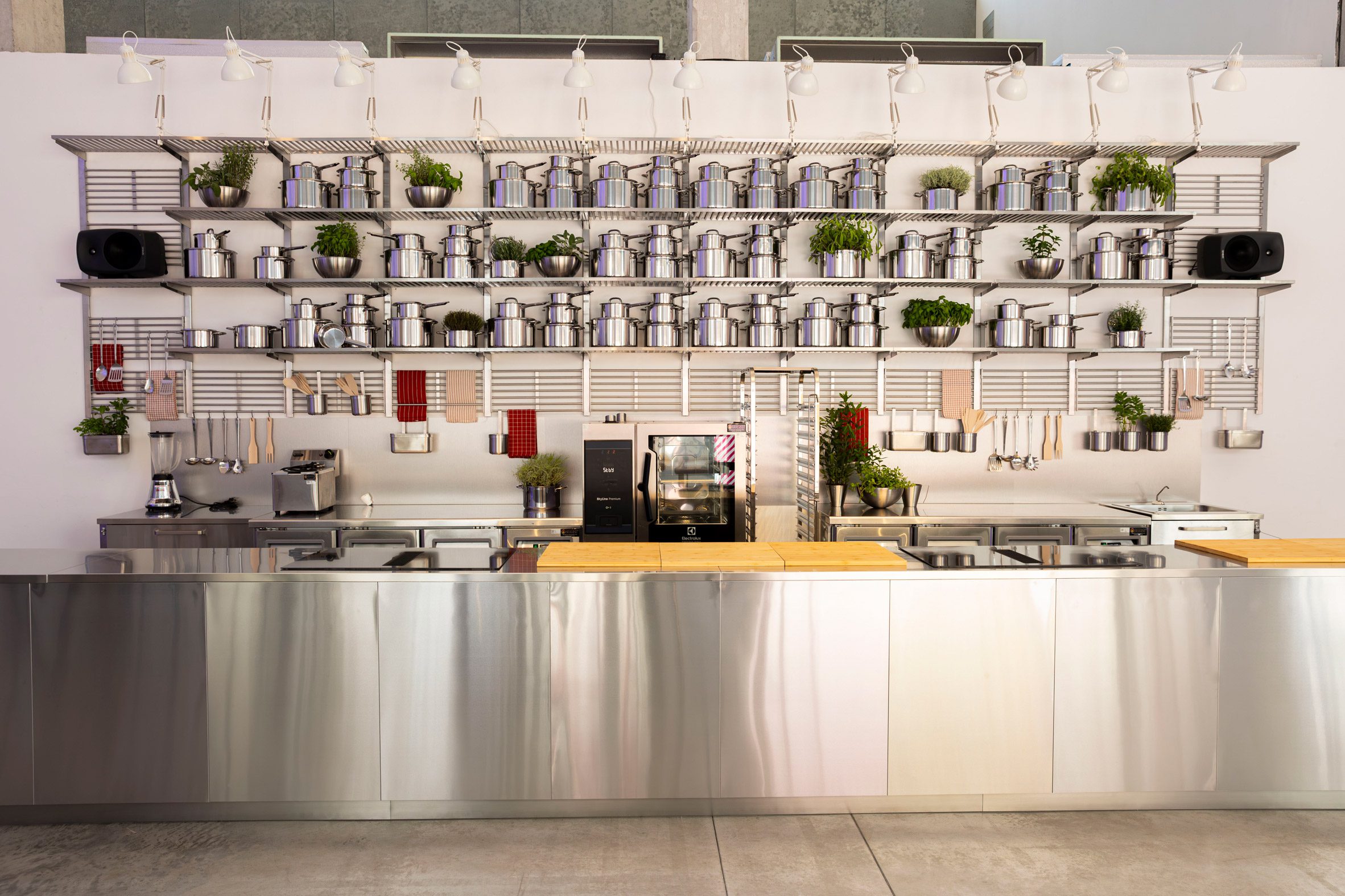 Kitchen at IKEA's Food for Thought exhibition with worktops, shelving and cooking equipment