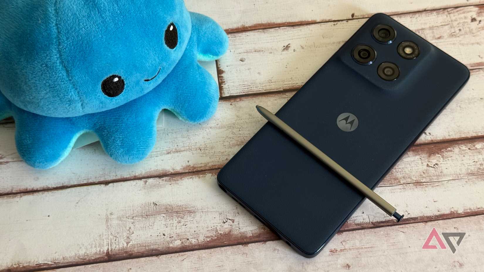 Moto G Stylus 2025 with the stylus removed next to a plushie